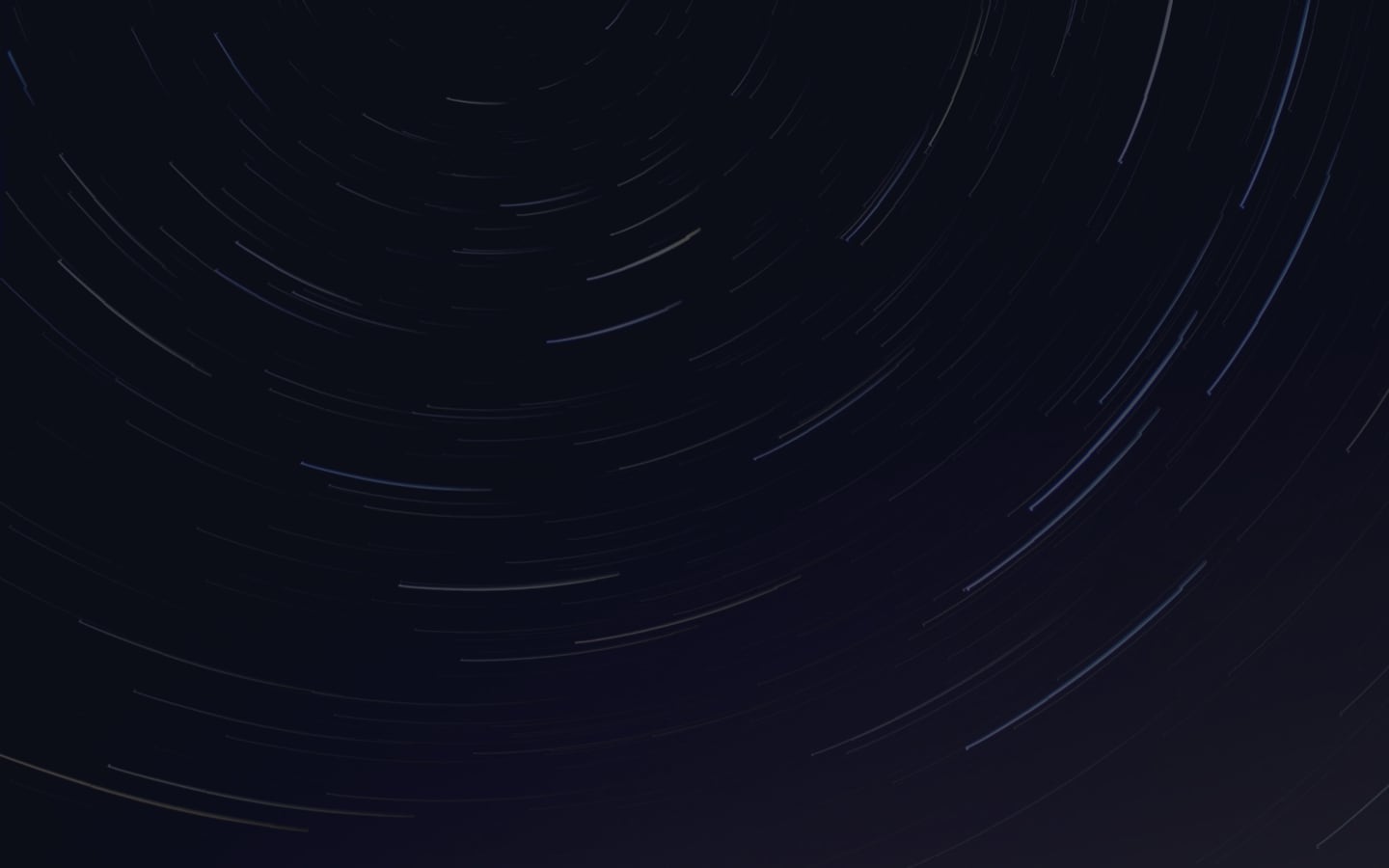 Star trails dance across the midnight canvas, leaving ethereal arcs of light.