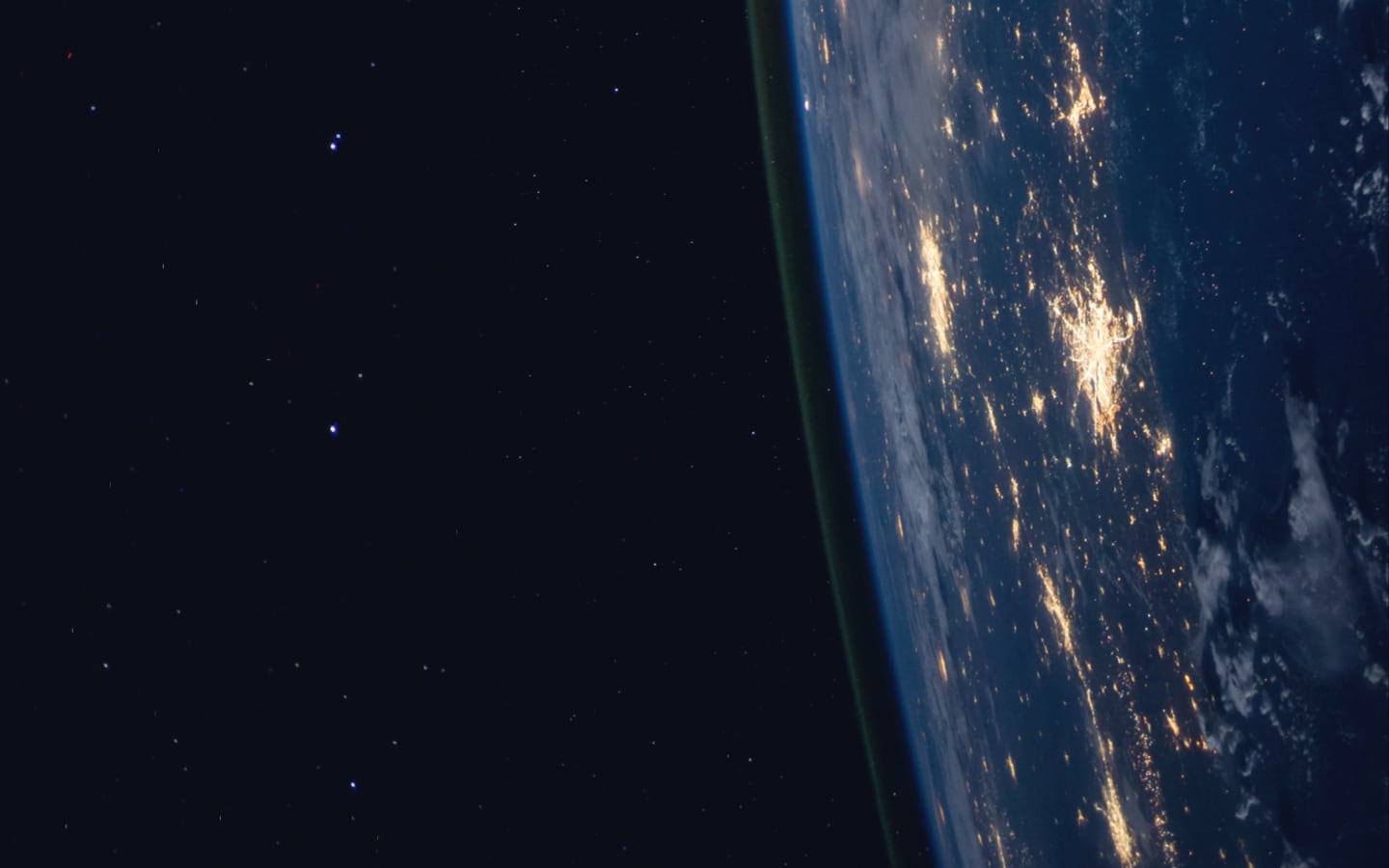 A breathtaking nighttime image of Earth, illuminated by the glow of urban centers against a backdrop of stars.