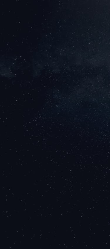 A night sky filled with stars, with the Milky Way galaxy visible as a faint band across the center.